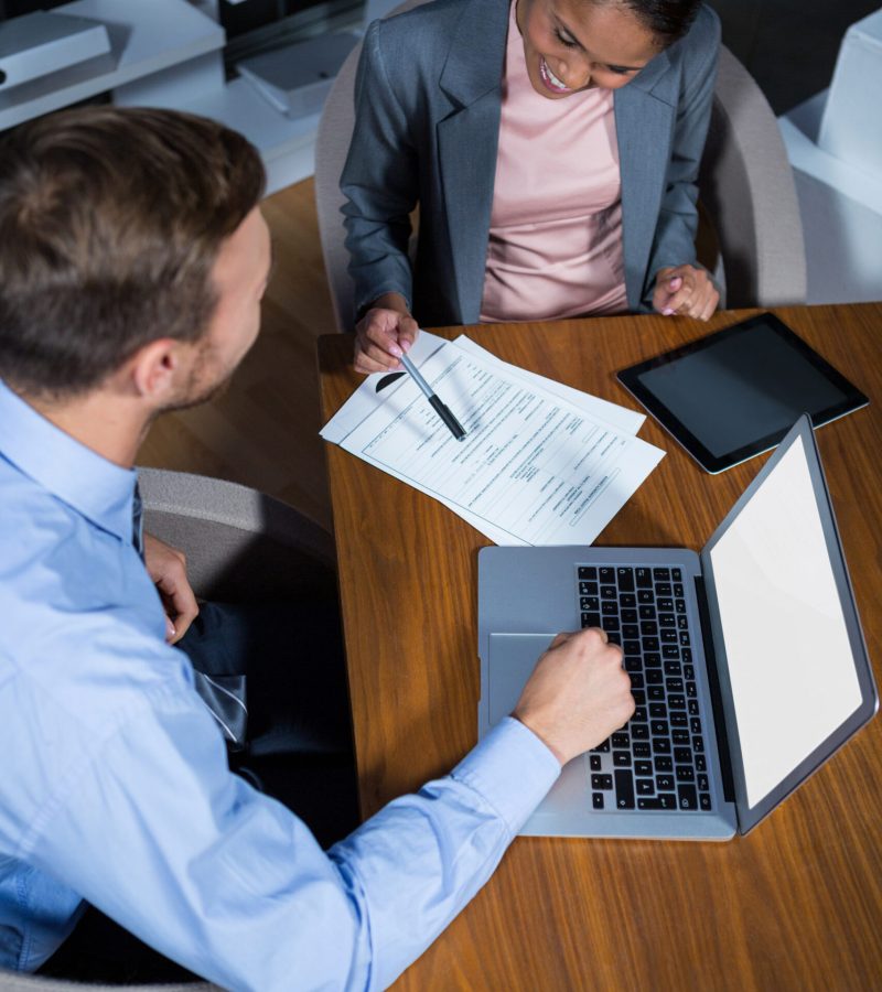 Businessman and businesswoman working in office at night